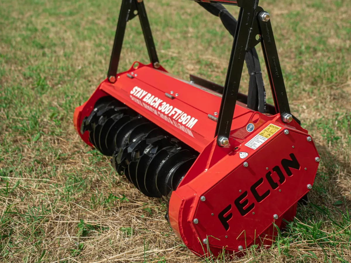 Close view of the Fecon mulcher housing and cutting rotor.