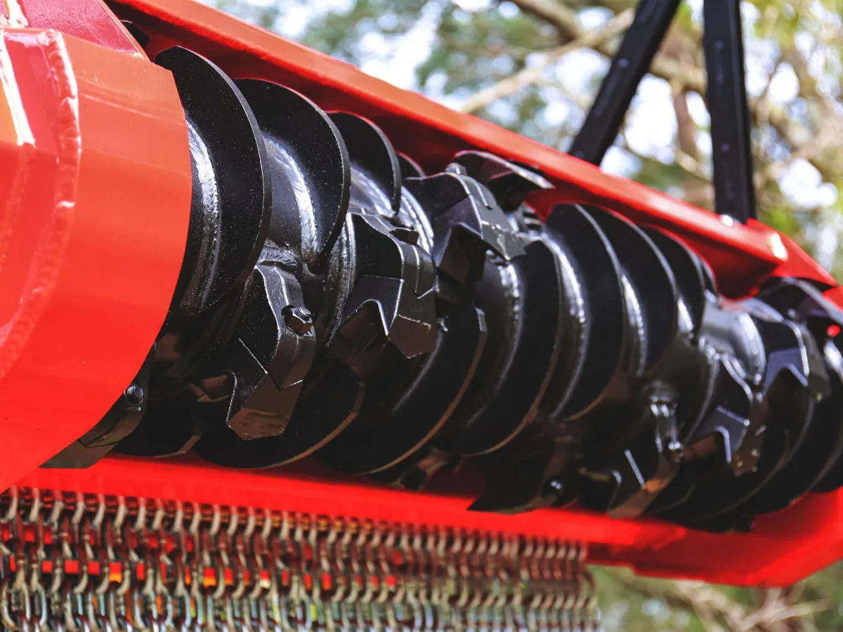 Close-up of the Fecon mulcher rotor and cutting teeth.